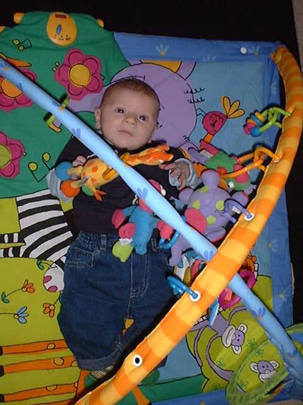 [Tom plays on his playmat!]