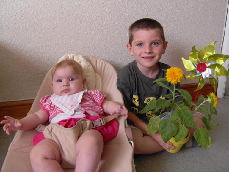 [Tom shows off his sunflowers]