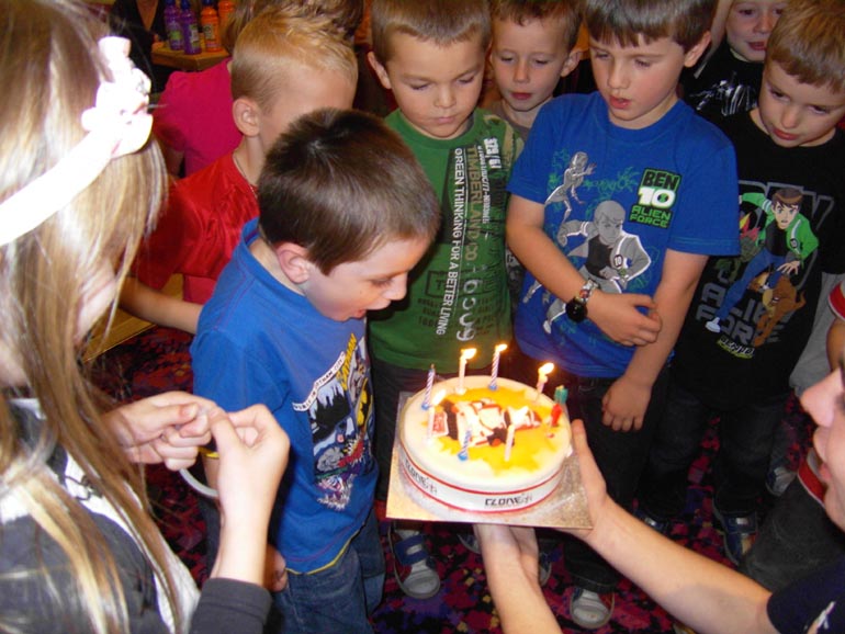 [Tom blowing out the candles on his cake]